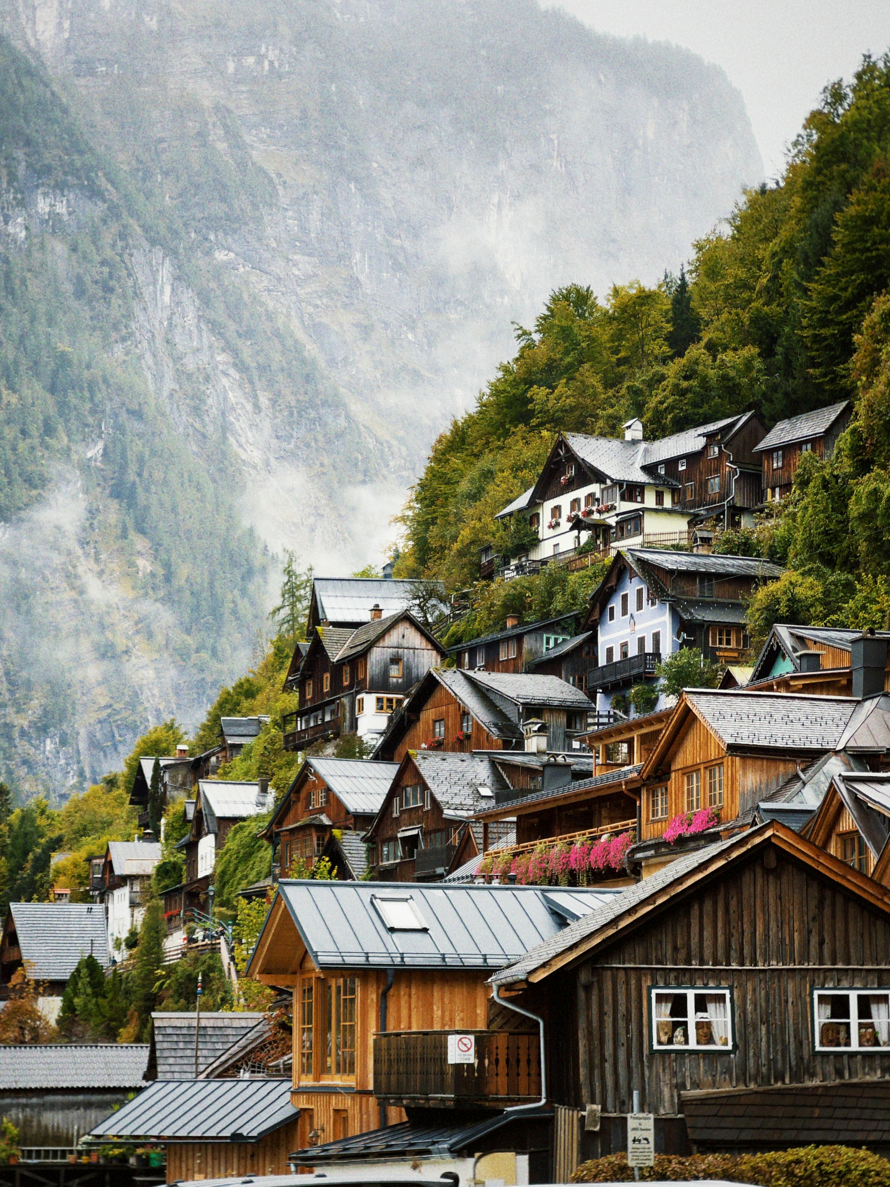 Charming Alpine village nestled on a hillside with traditional wooden houses and lush greenery.
