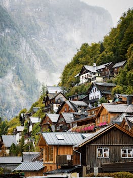 Charming Alpine village nestled on a hillside with traditional wooden houses and lush greenery.