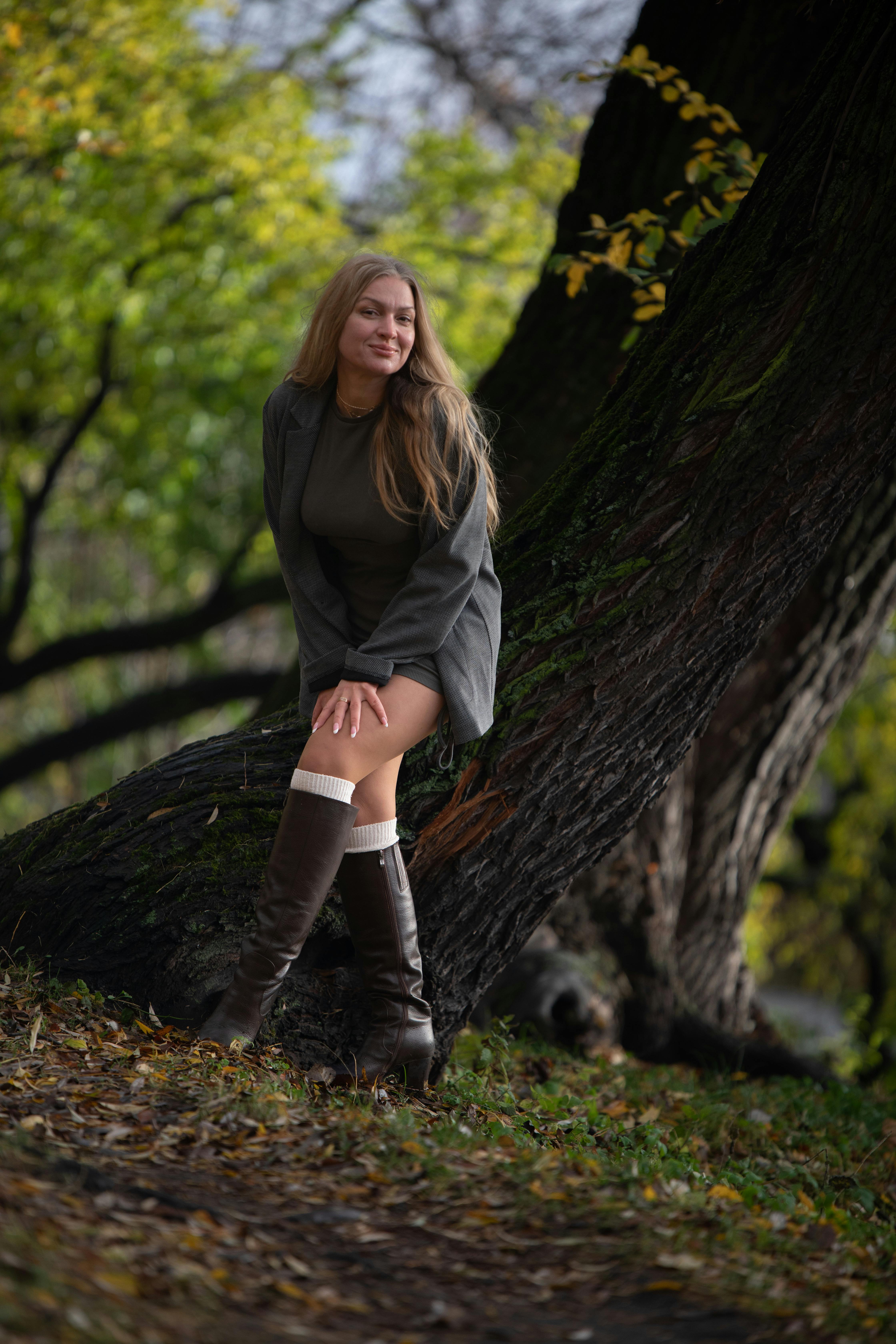 Sensual woman in relaxed dreamy pose amid soft natural light, evoking deep trance and autumn serenity