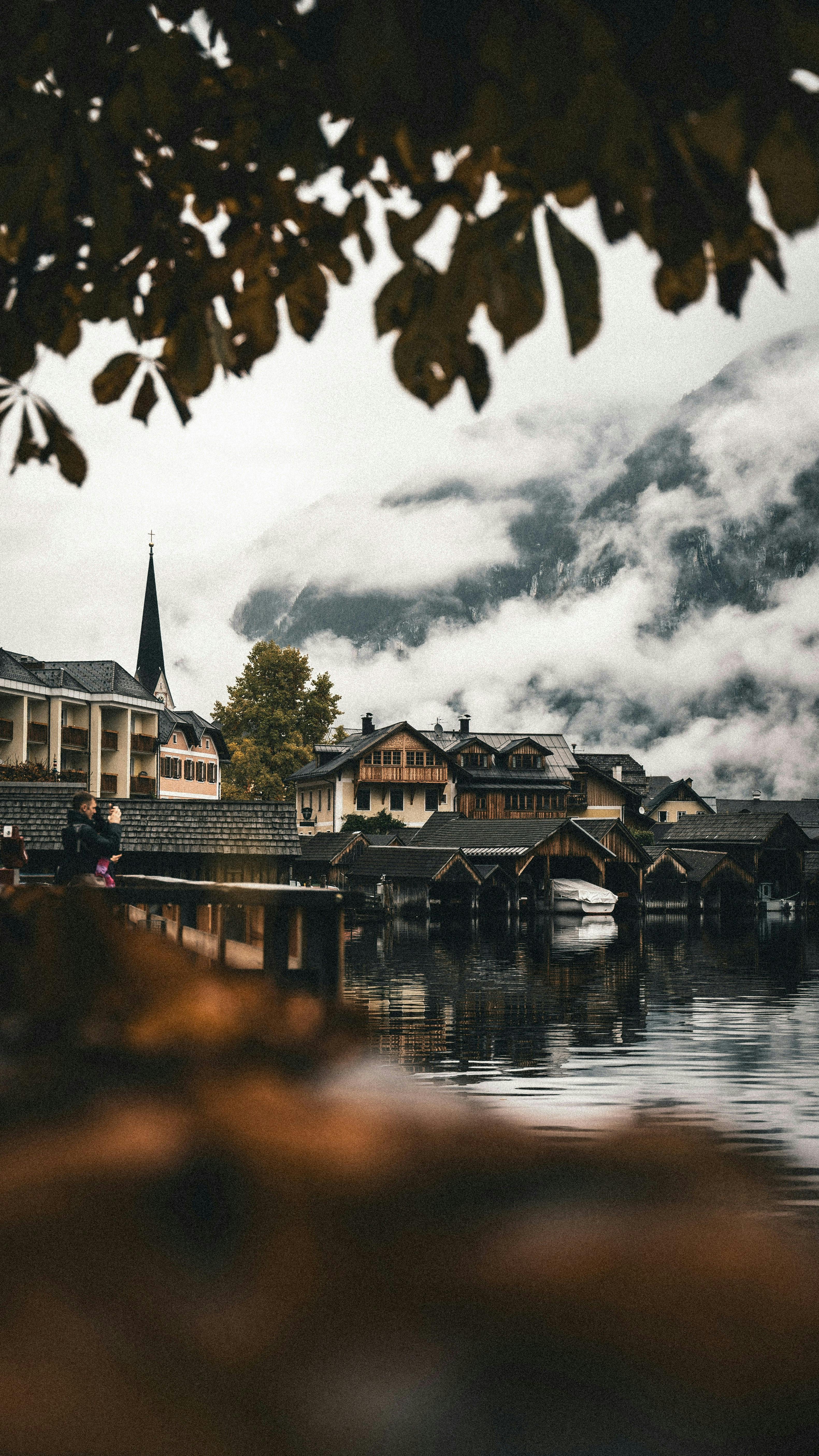 Charming lakeside village of Hallstatt with misty Alps in the background.