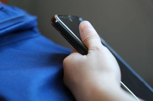 Free Hand Holding a Smartphone Stock Photo