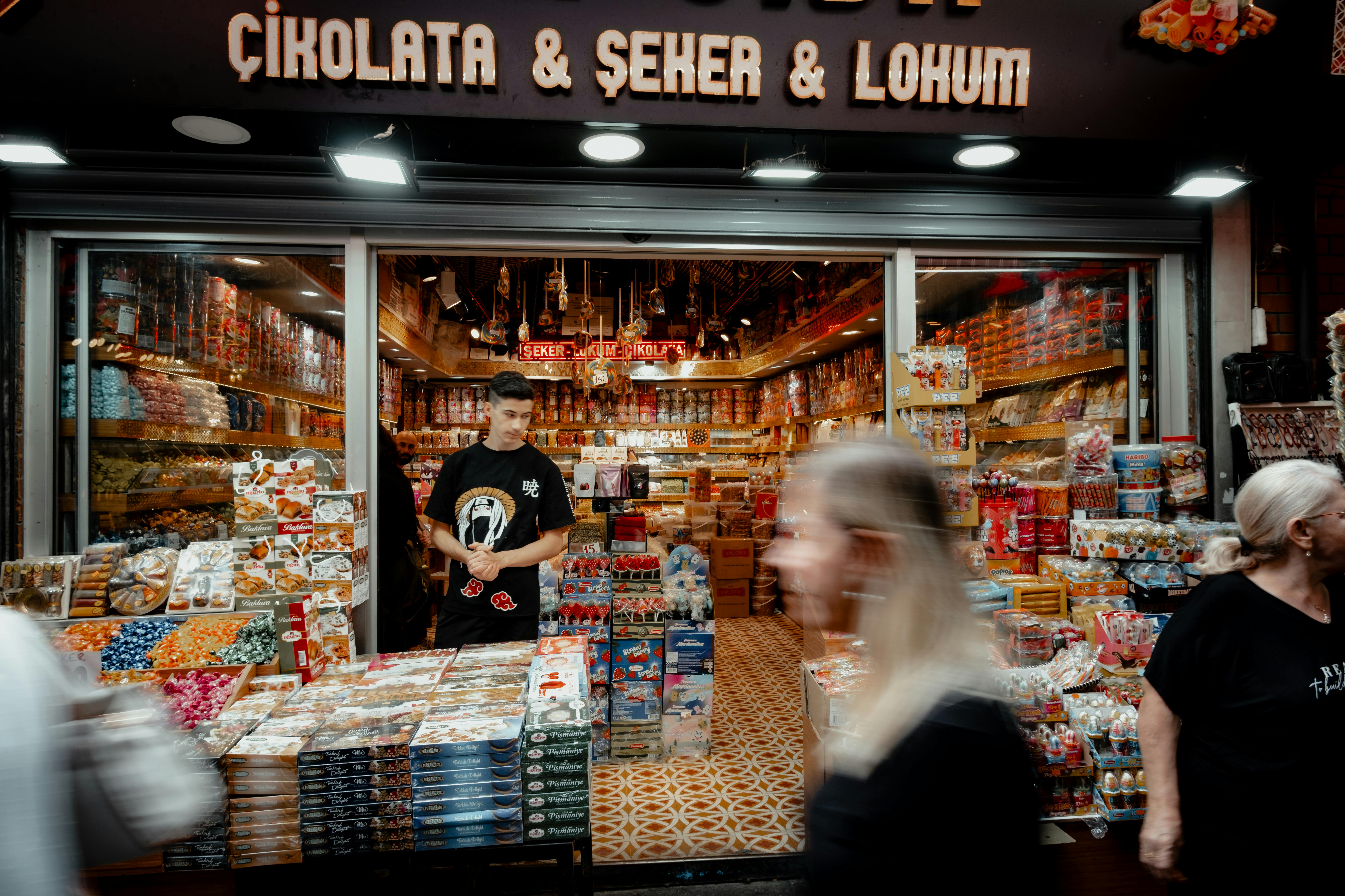Vibrant scene of a bustling Turkish candy shop in Istanbul's famous bazaar, showcasing a variety of sweets.
