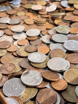 A collection of various international coins, silver, bronze, and copper, in a pile.
