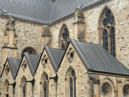Free A detailed shot of a Gothic cathedral showcasing its stone architecture and arched windows. Stock Photo