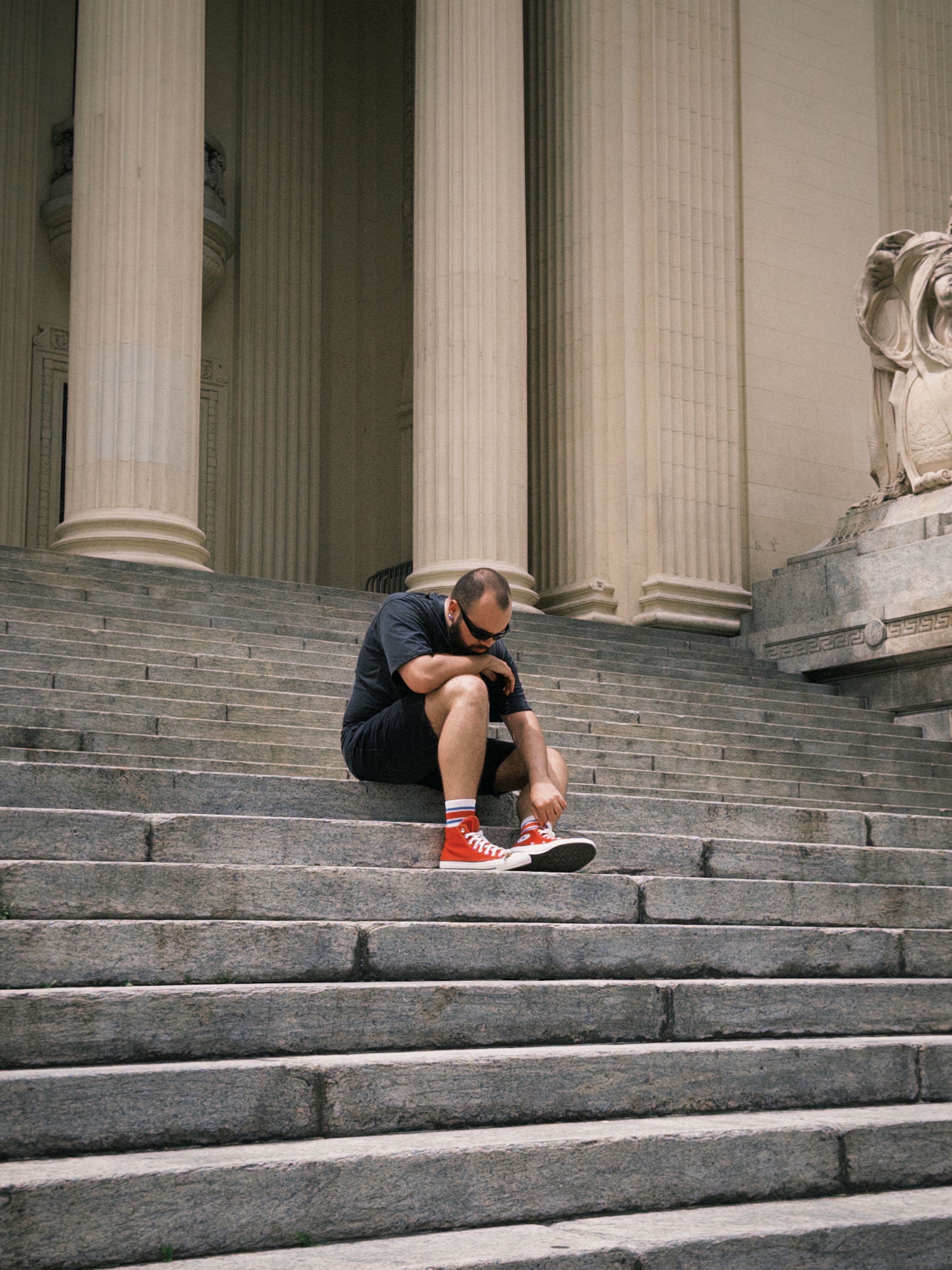 Contemplative Moment on Urban Stone Steps · Free Stock Photo