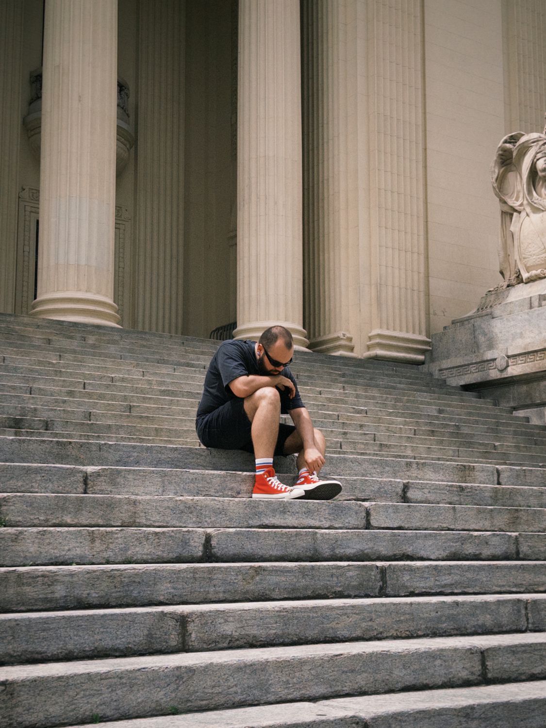 Contemplative Moment on Urban Stone Steps · Free Stock Photo