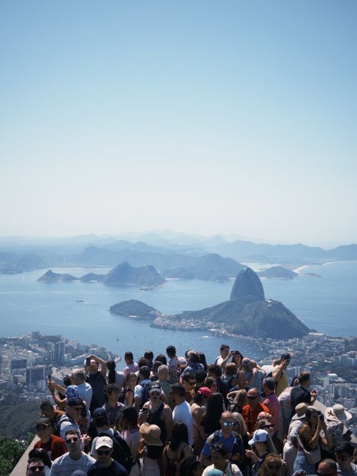 Free A large crowd gathers at a viewpoint overlooking Sugarloaf Mountain in Rio de Janeiro, Brazil. Stock Photo