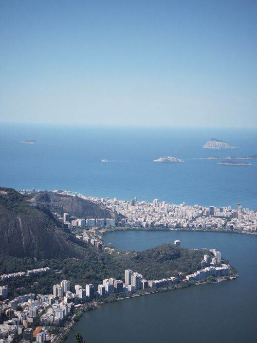 Free A breathtaking aerial view of Rio de Janeiro's coastline and cityscape under a clear blue sky. Stock Photo