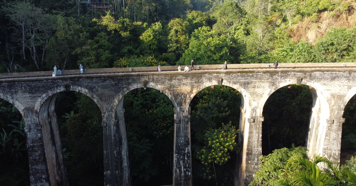 Aerial view of the iconic Nine Arches Bridge in lush green Ella, Sri Lanka.