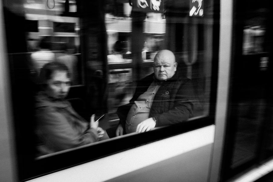 Black and white photo of passengers inside a tram in Dublin, Ireland