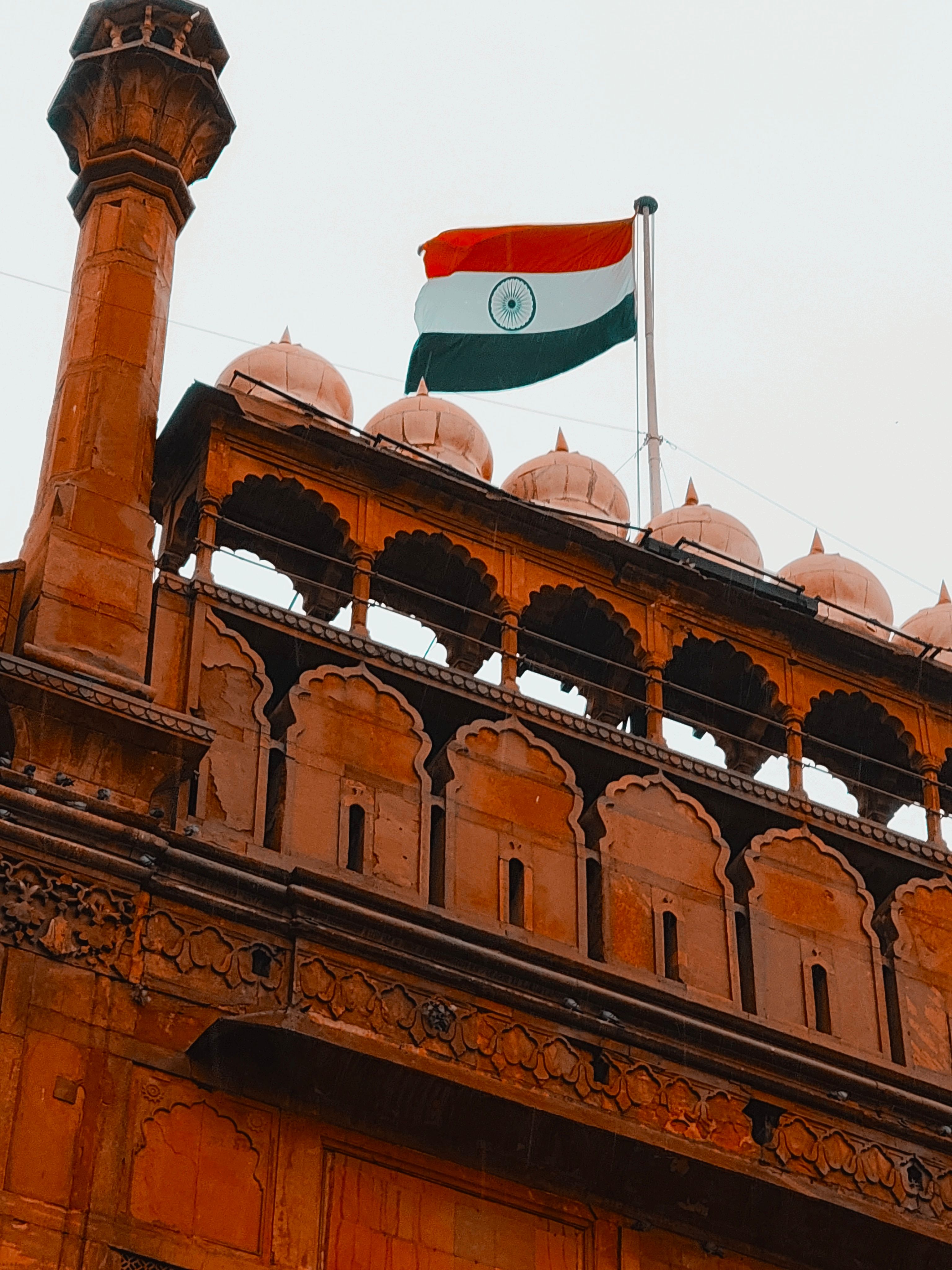 Historic Red Fort with Indian flag in Delhi, India, symbolizing independence.
