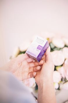 Close-up of hands holding Botox Cosmetic box, embodying beauty and wellness.