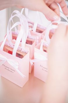 Pink aesthetic gift bags with ribbon handles, ideal for beauty clinics and wellness centers.