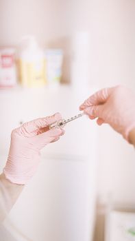 A professional prepares a cosmetic injection in a modern spa, focusing on skincare and wellness.