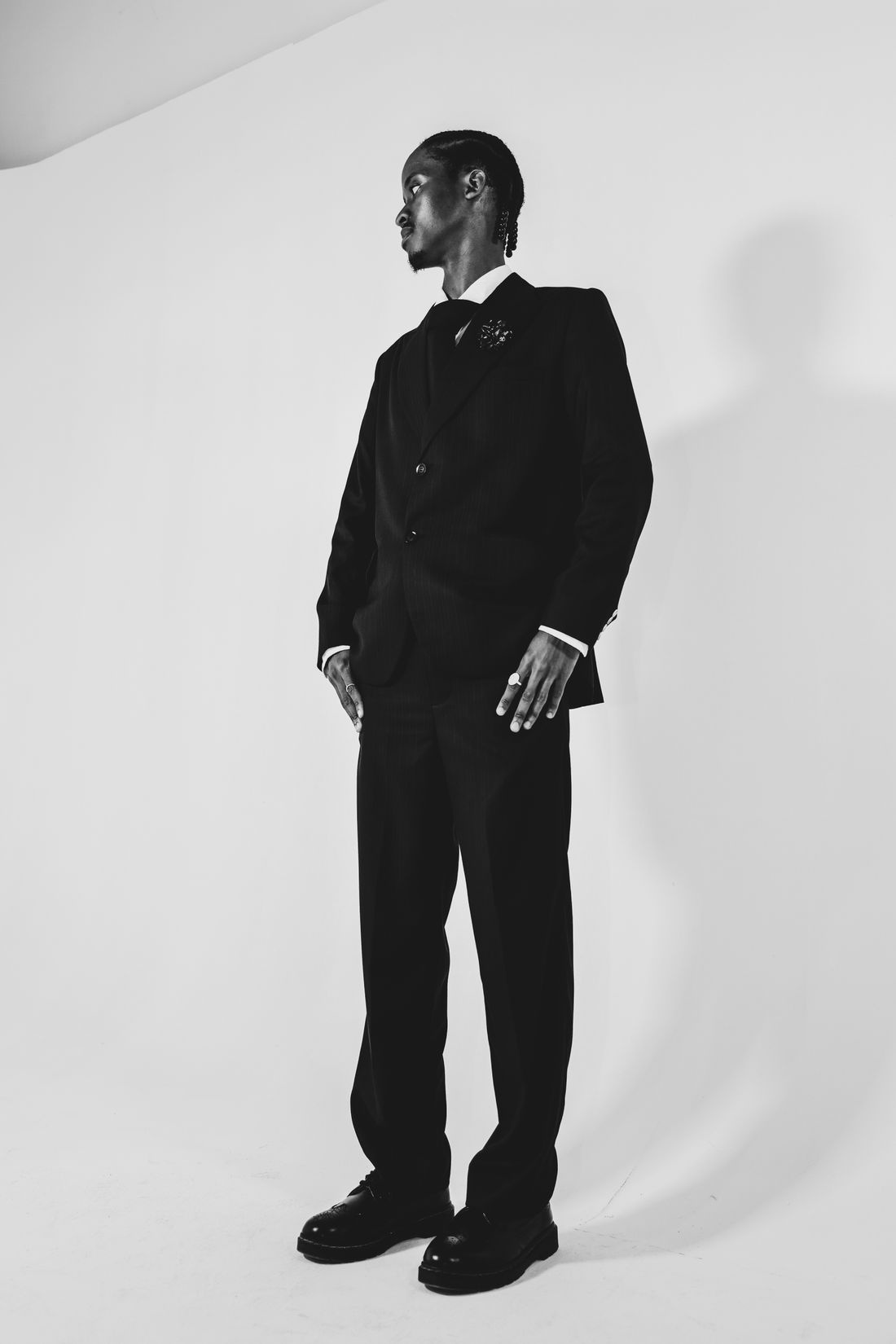 Full-length tailored silhouette photographed against a pale studio wall