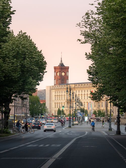 Free Captivating view of Berlin's Rotes Rathaus amid bustling street activity at twilight. Stock Photo
