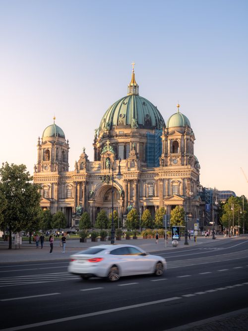 Free A beautiful shot of the Berlin Cathedral during daytime with motion blur effect from passing cars. Stock Photo