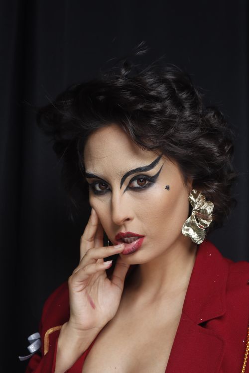 Free Stunning portrait of a woman with bold makeup and red attire, exuding elegance. Stock Photo