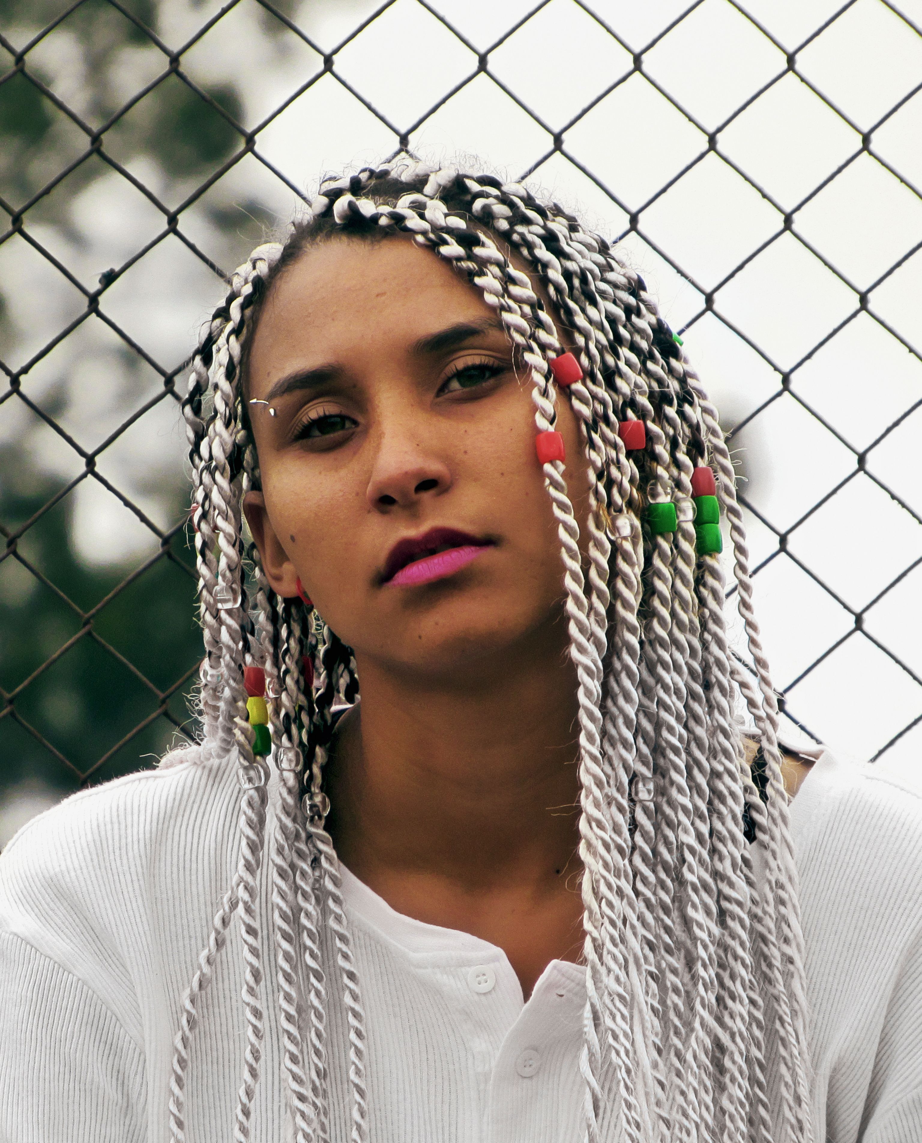 Portrait of a Woman with Braided Hair Outdoors · Free Stock Photo