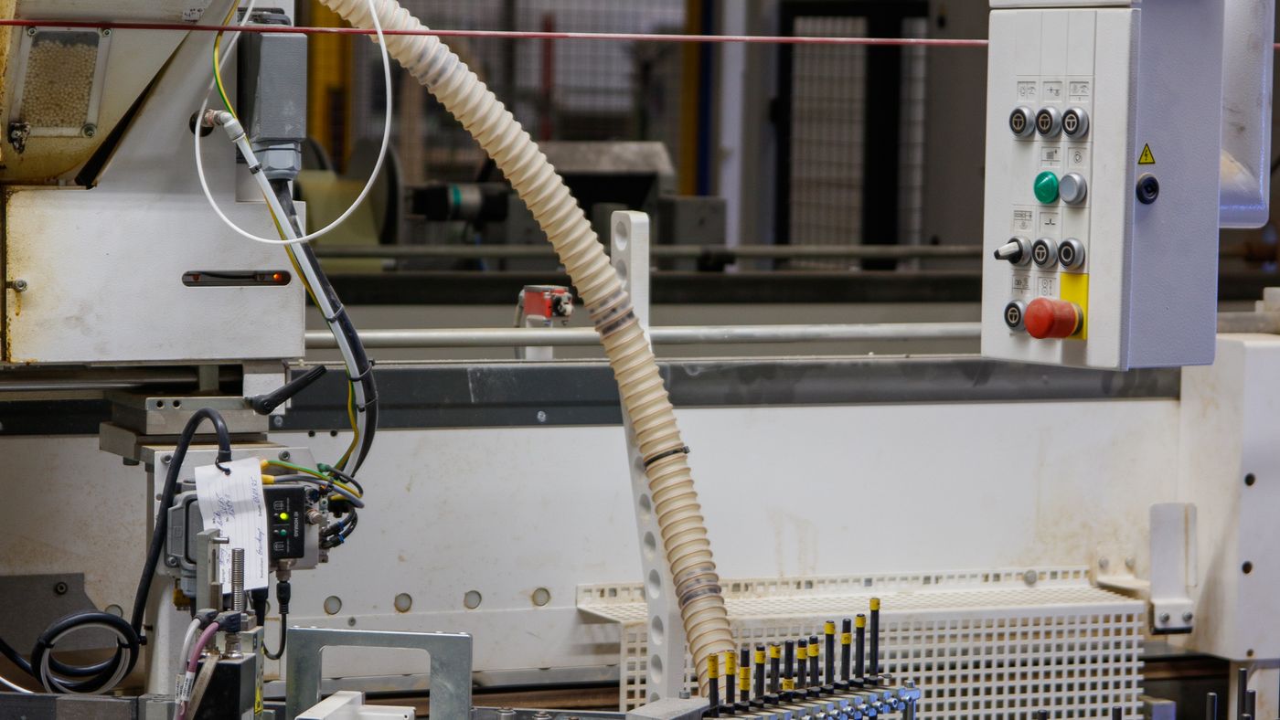 Automated injection molding machinery with material feed