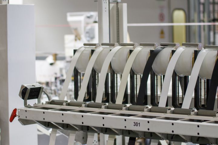 Modern industrial machine in operation in a manufacturing facility showcasing advanced technology.