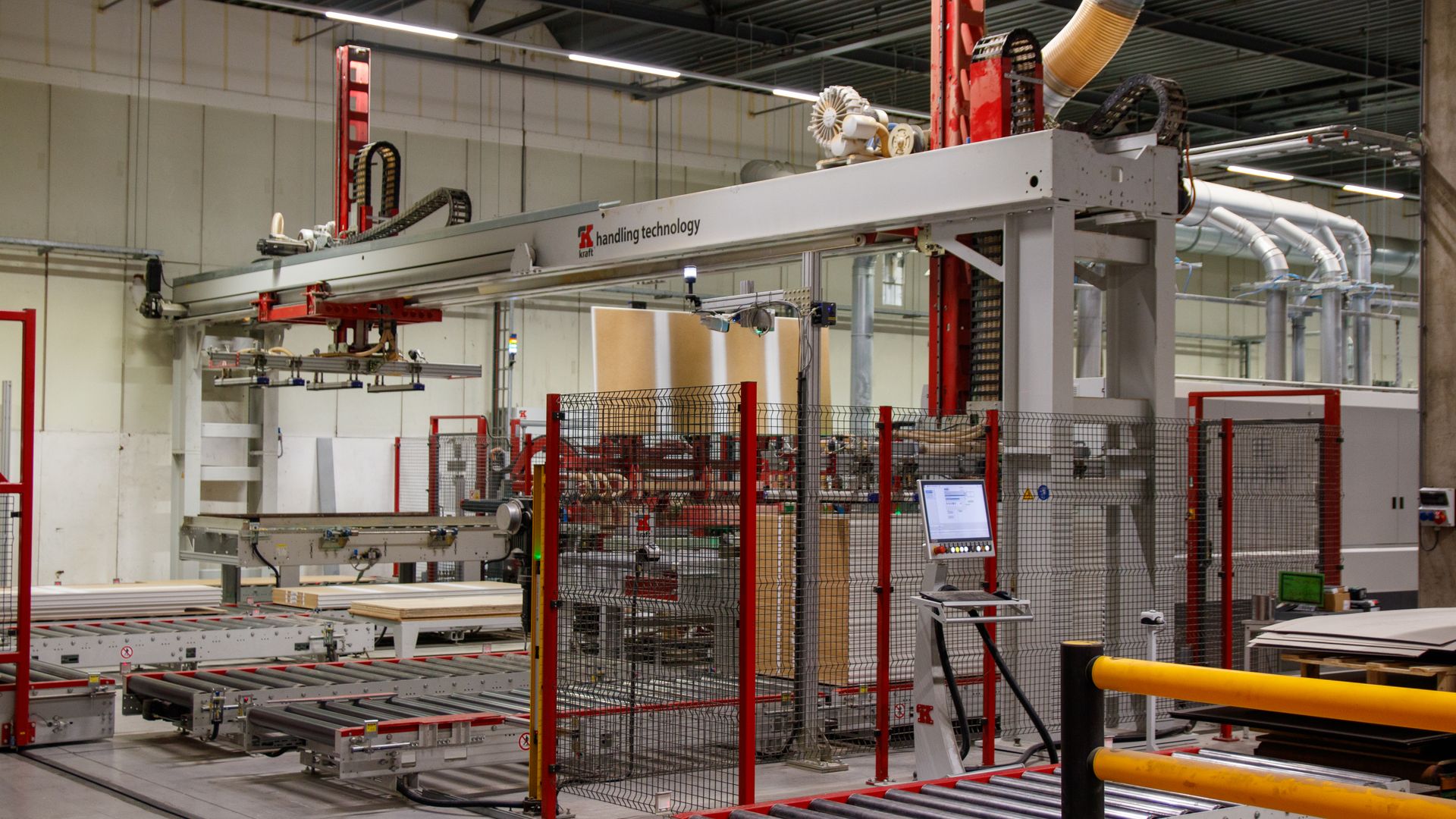 Automated manufacturing line with robotic arm inside a modern industrial facility