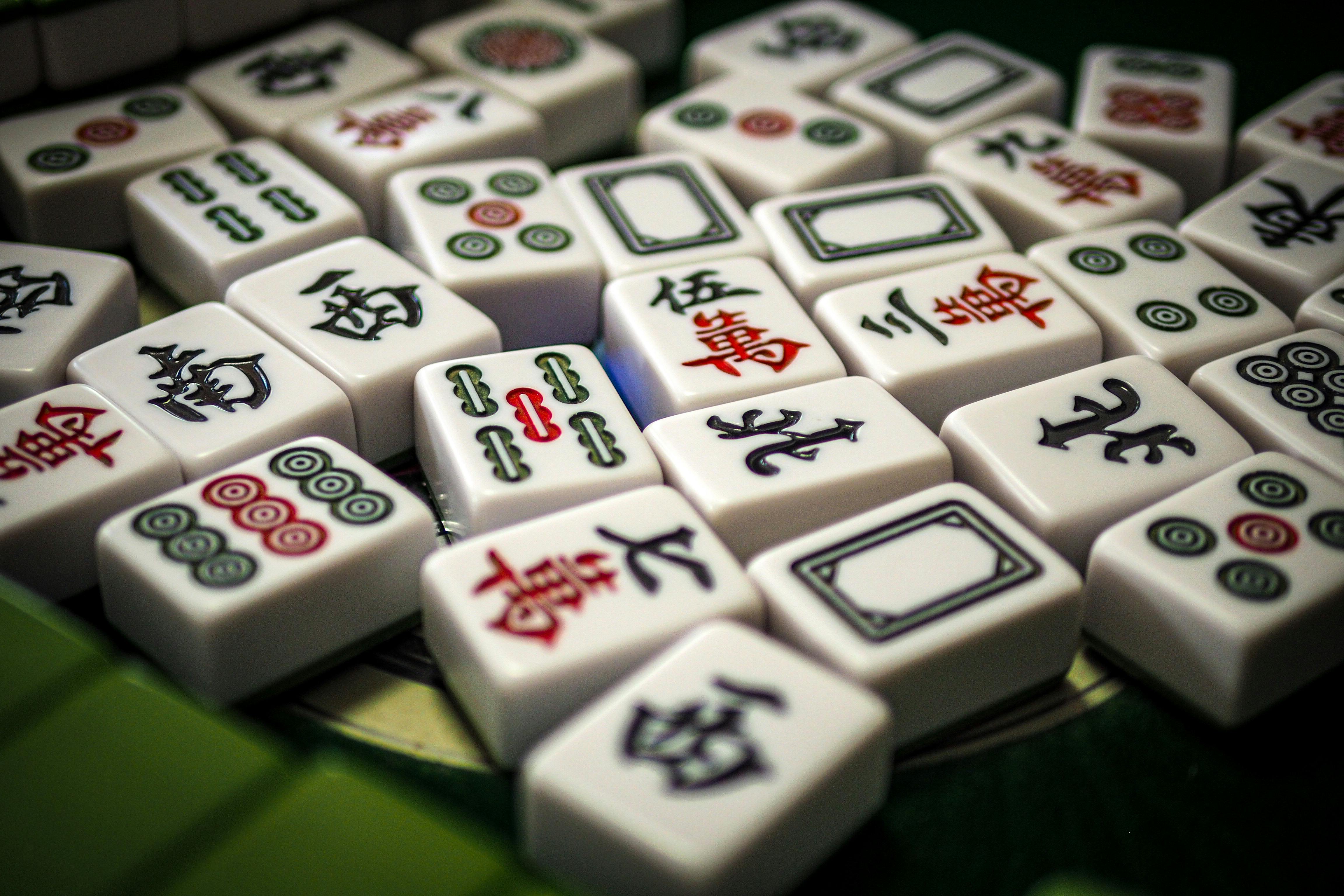 Close-up of Mahjong tiles showing Chinese characters, ideal for games and hobbies theme.