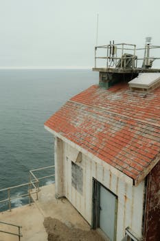 古老的灯塔，拥有红瓦屋顶和海洋背景，非常适合宁静的旅行视觉效果