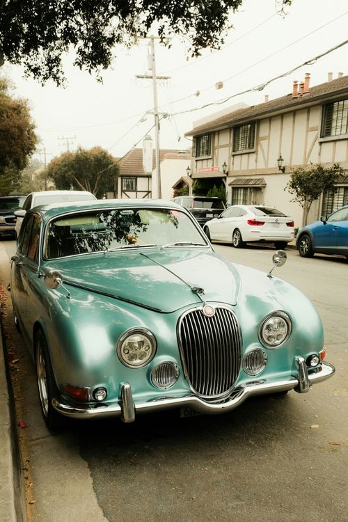 Free Vintage turquoise Jaguar parked on a quaint street in Carmel-by-the-Sea, California. Stock Photo