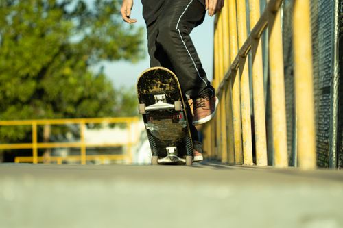 Free Close-up of skateboarder performing a trick on a rail outdoors, showcasing skill and balance. Stock Photo