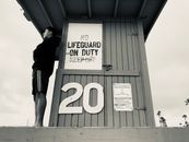 Man Standing on the Life Guard House