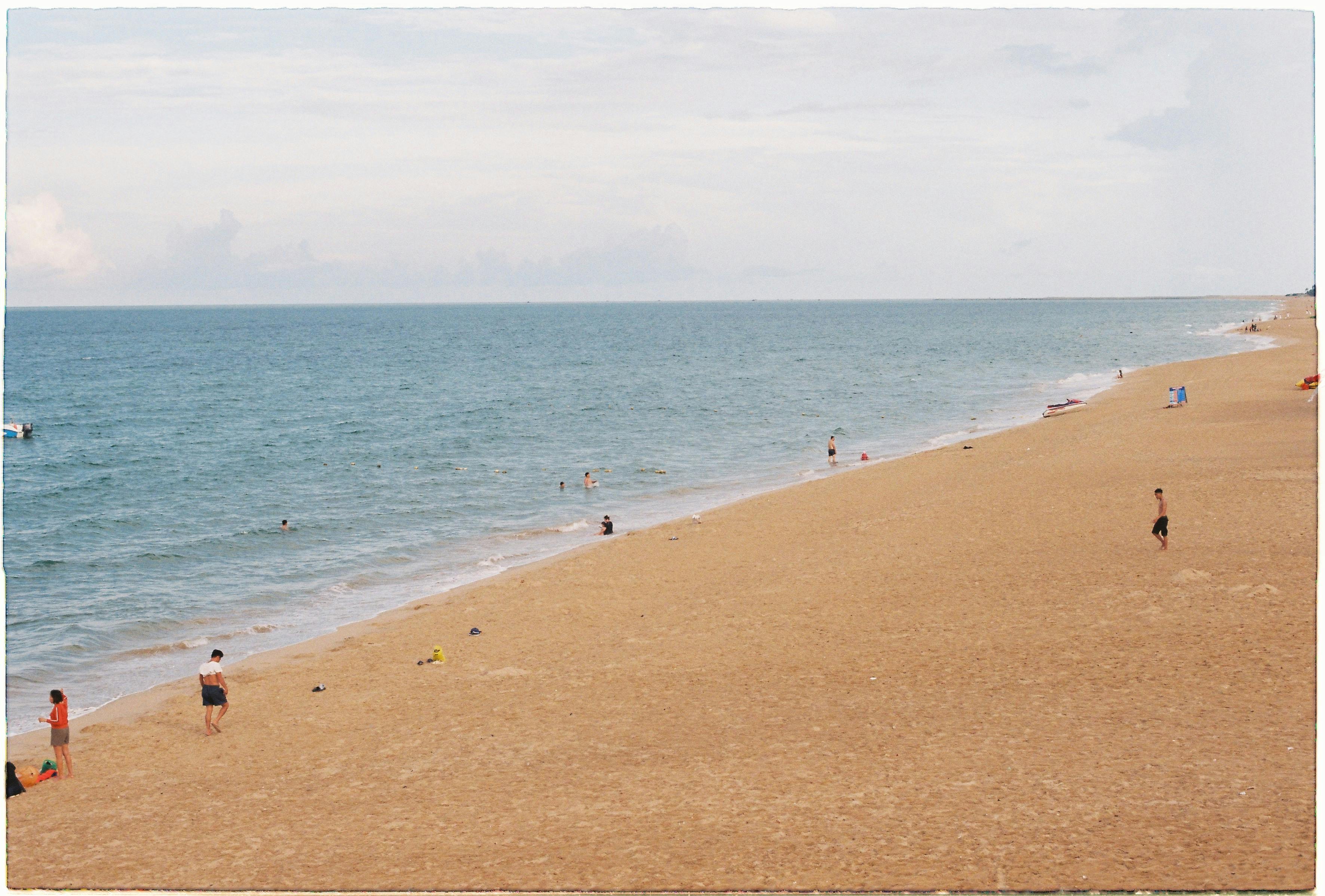 宁静的海滩上，人们享受着阳光明媚的日子