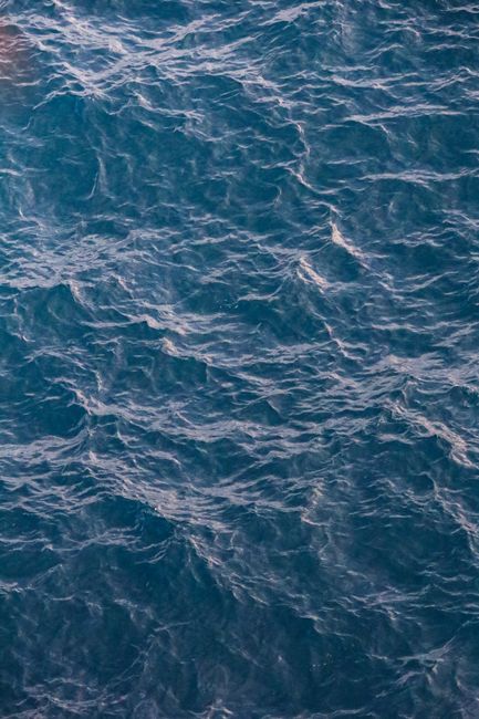 Beautiful aerial shot of ocean waves, showcasing the deep blue sea in a serene, tranquil setting.