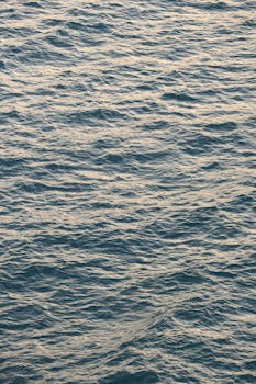 Capture of gentle ocean waves creating a serene and calming effect at sunset.