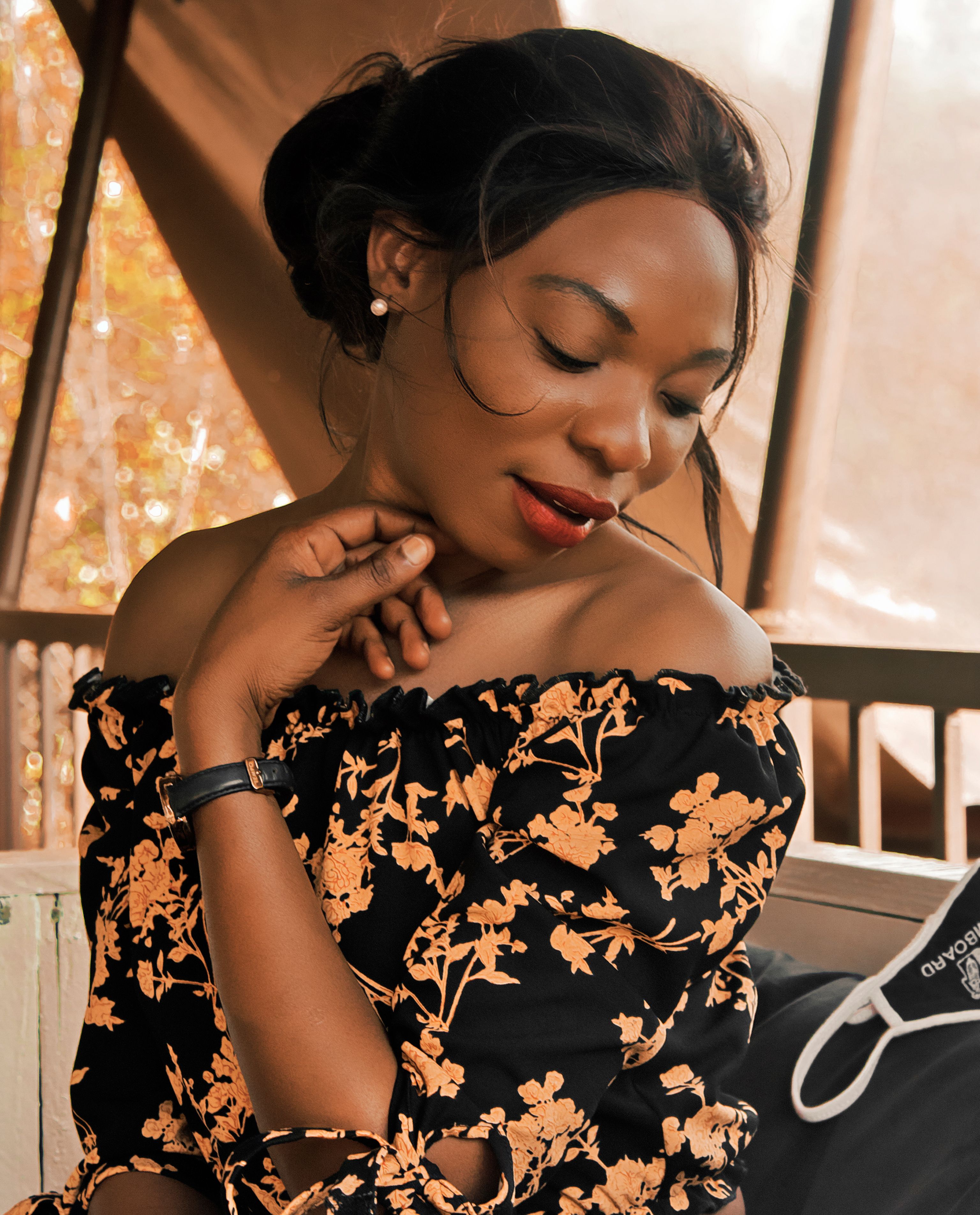 Elegant Woman in Floral Dress Relaxing Indoors · Free Stock Photo