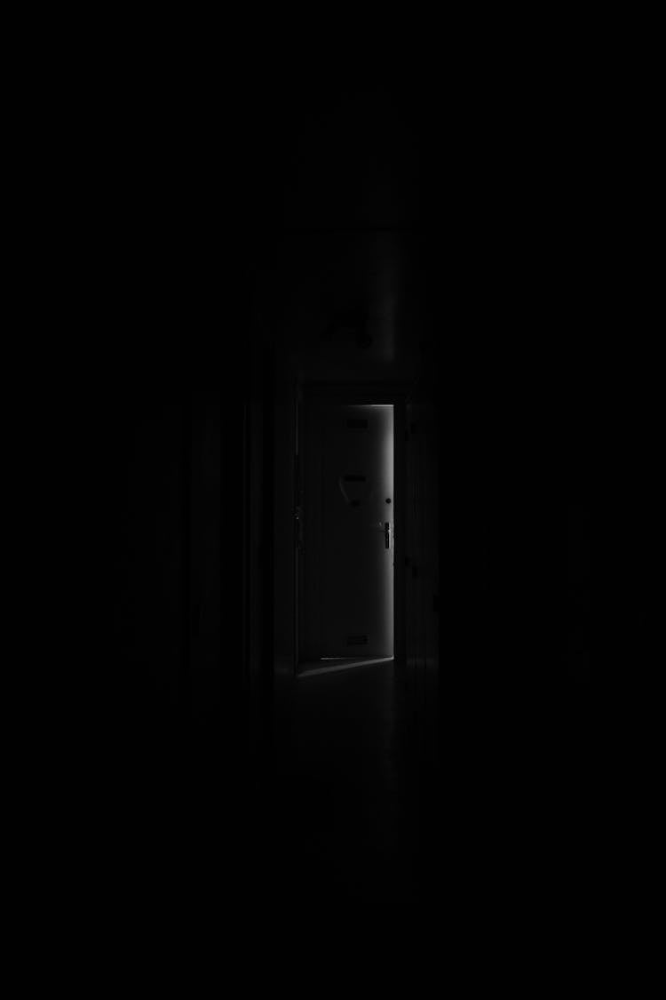 Ajar Door In Dark Interior