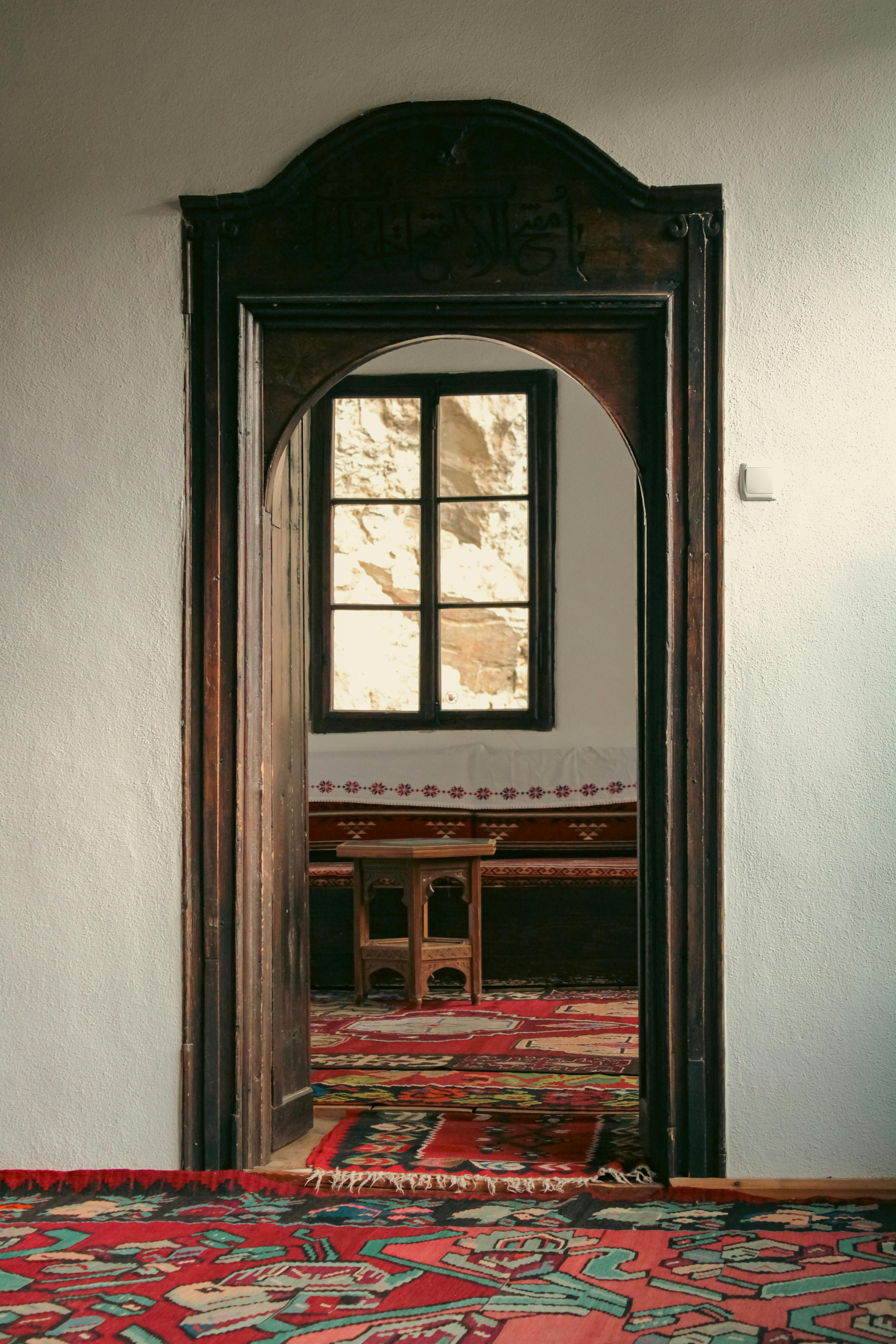 Explore the elegant interior of a Bosnian building with a beautifully carved wooden doorway.