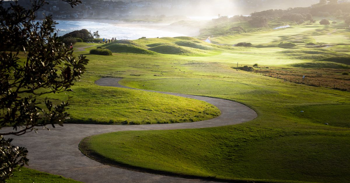 A winding coastal path with ocean views and green vegetation