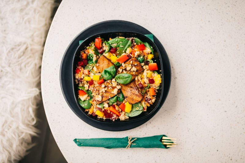 Colorful quinoa salad in a black bowl