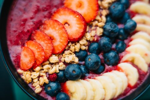 Free Delicious and colorful smoothie bowl topped with fresh fruits and granola, perfect for a healthy breakfast. Stock Photo