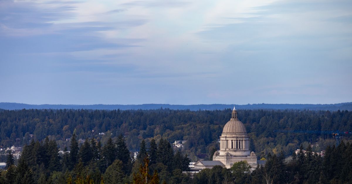View of Washington State Capitol amidst lush forests in Olympia, Washington.