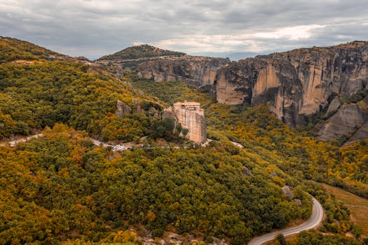 Stunning aerial view of Meteora monasteries nestled in autumnal landscape, Greece.