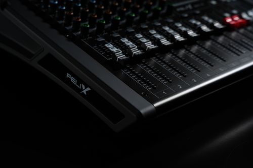 Free Detailed view of a professional audio mixing console with illuminated LED indicators, perfect for studio recording. Stock Photo