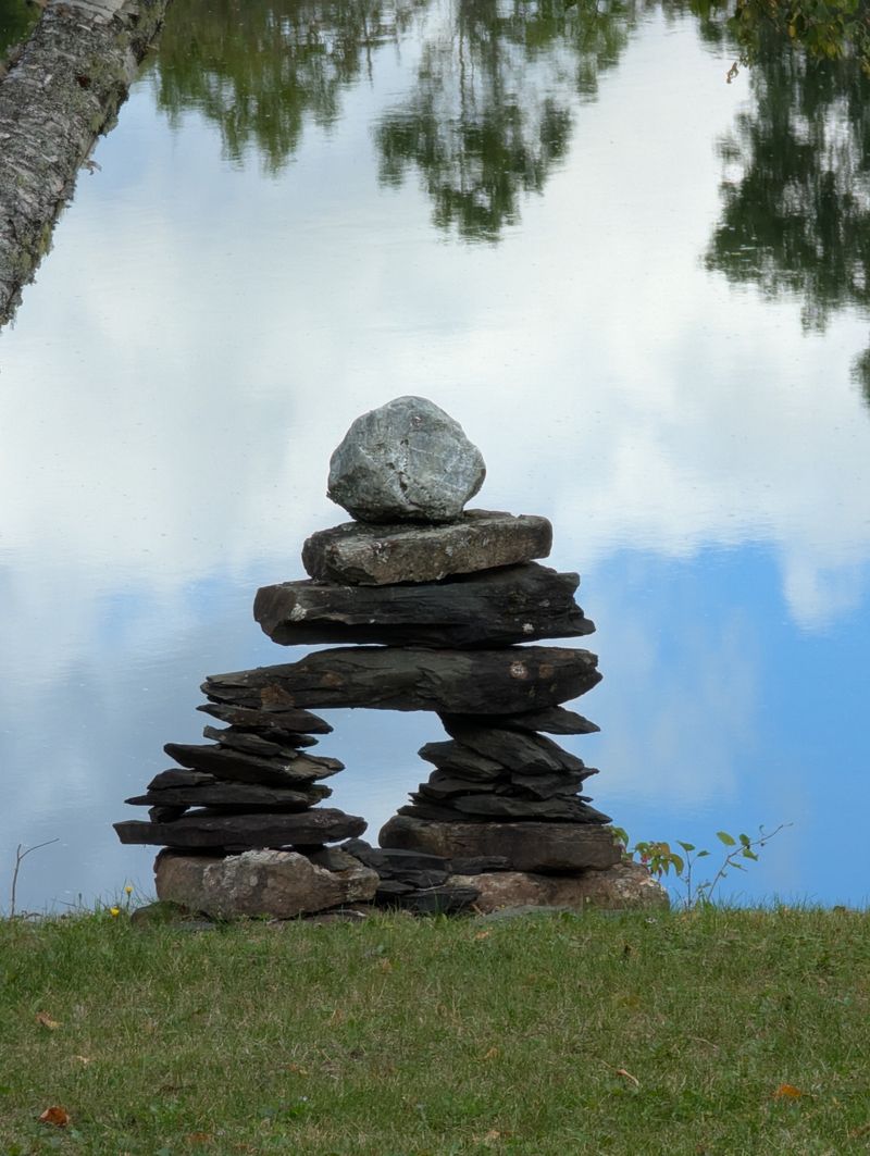 Calm balanced stones by a lake — PEMF as complementary physical support for anxiety and autonomic hyperarousal