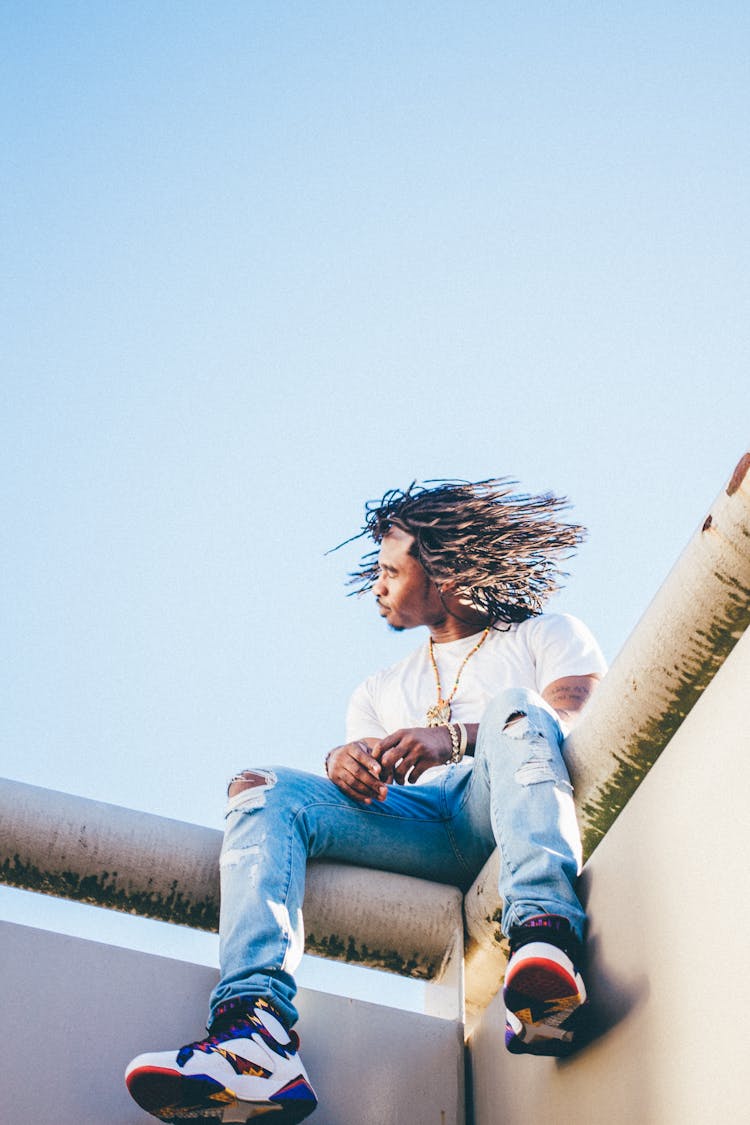 Man Sitting On The Ledge