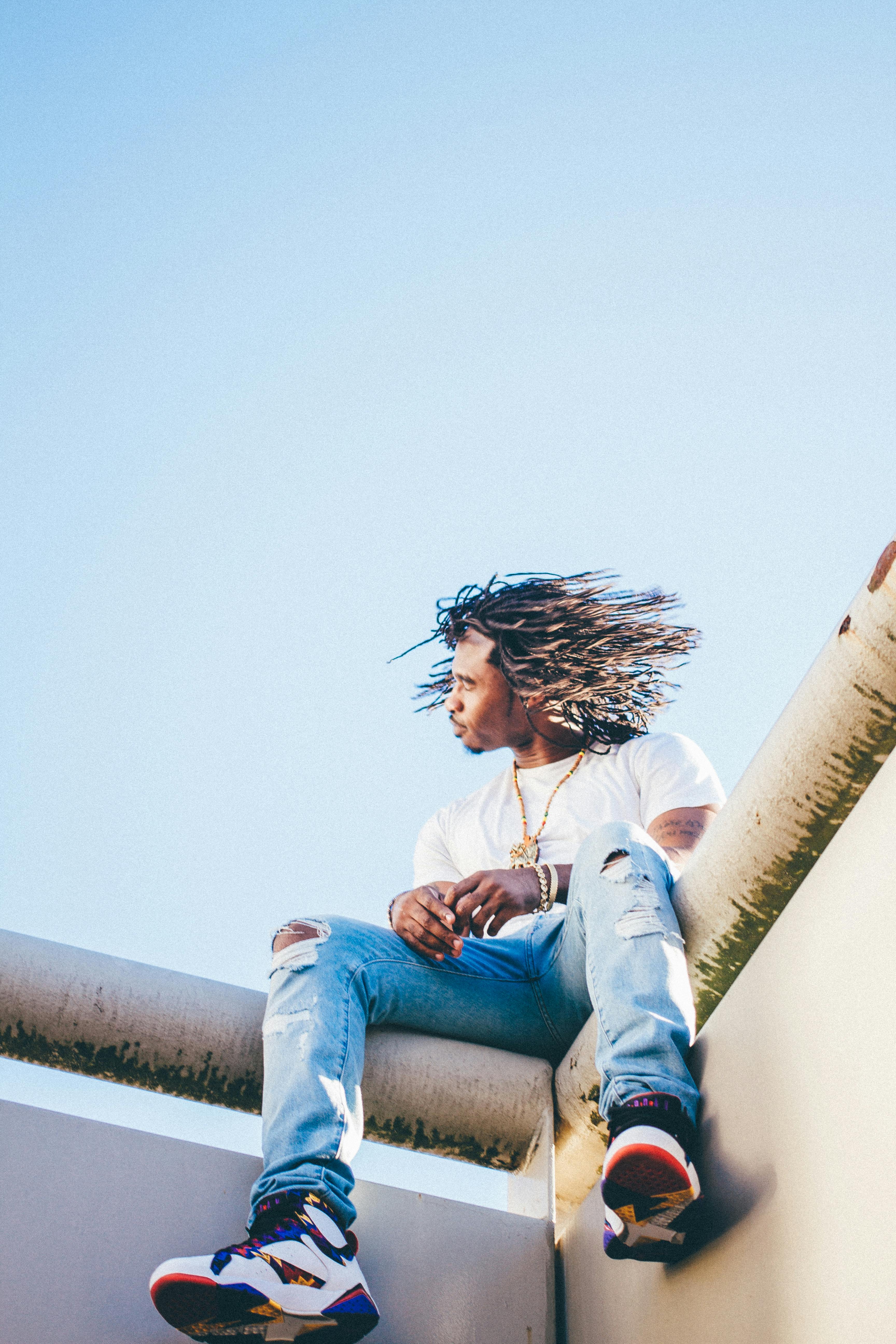 Man Sitting on the Ledge · Free Stock Photo