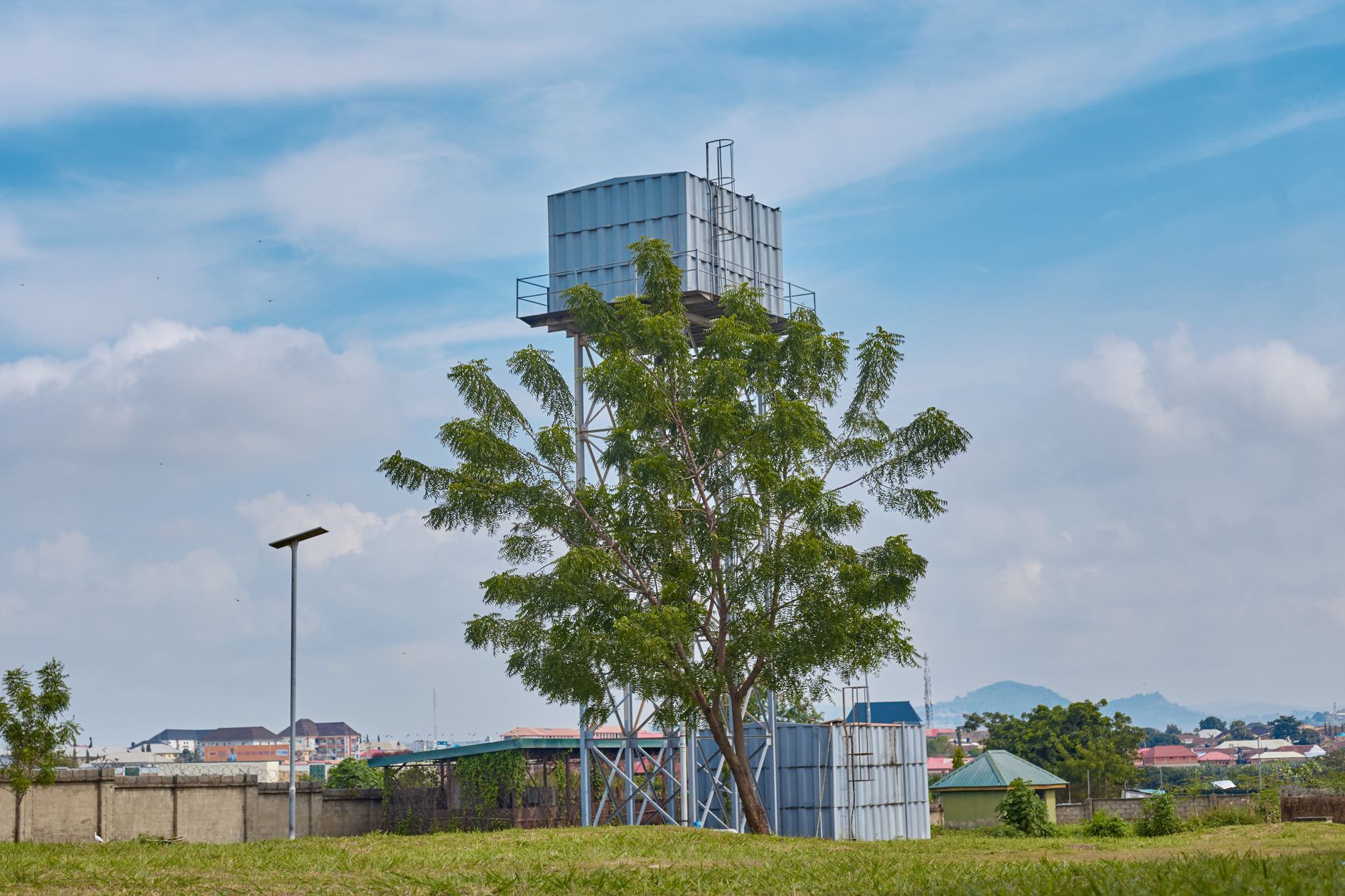 A standby generator and water storage tanks behind a Nairobi hotel