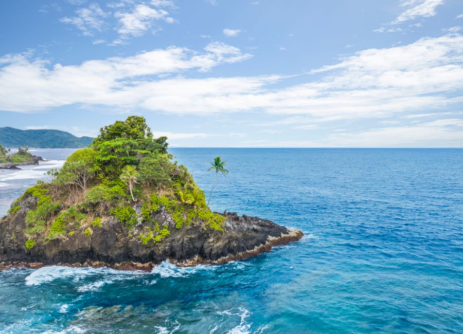 Explore the stunning Alega Beach with vibrant turquoise waters and lush greenery in American Samoa.