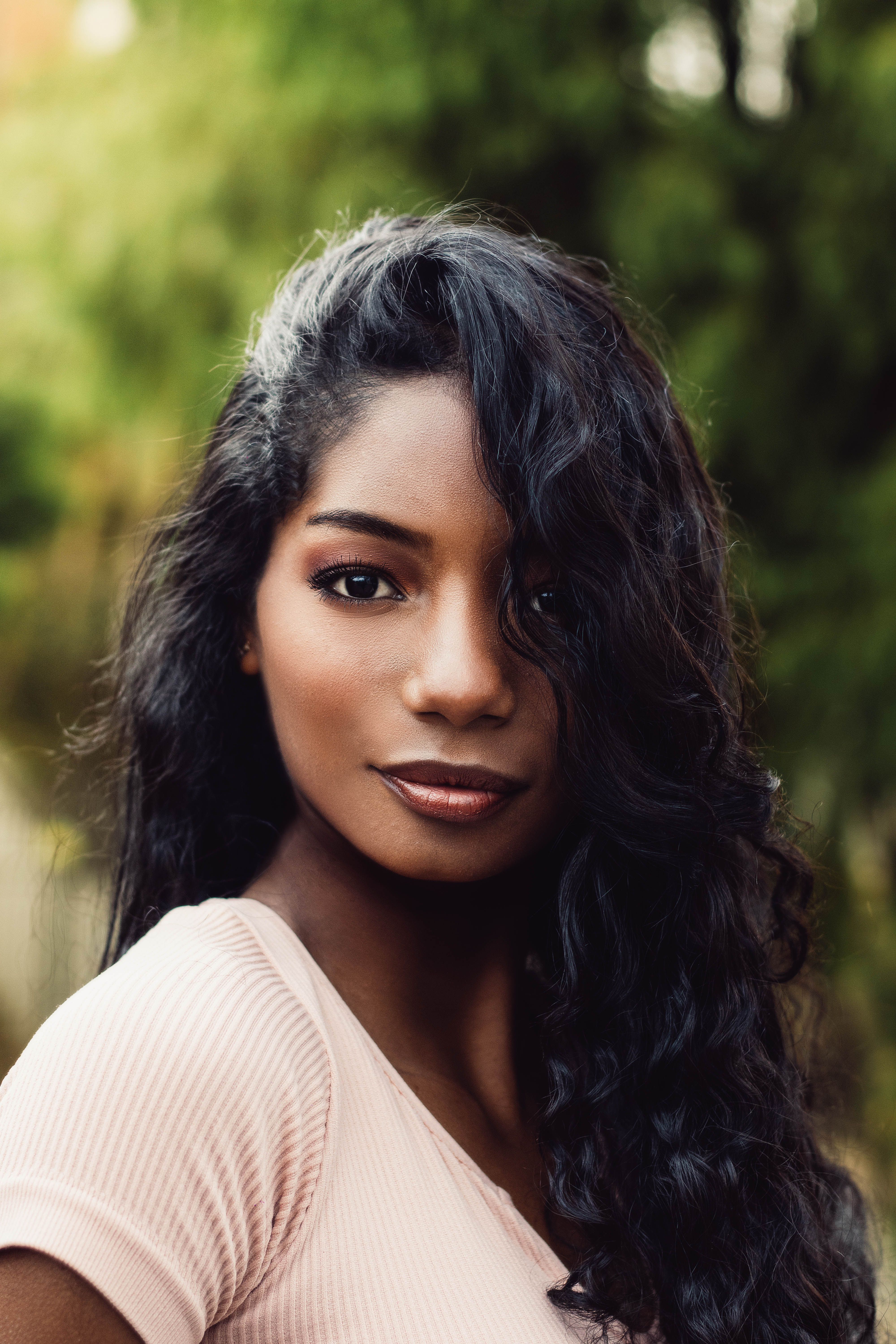 Portrait of a Woman with Curly Hair Outdoors · Free Stock Photo