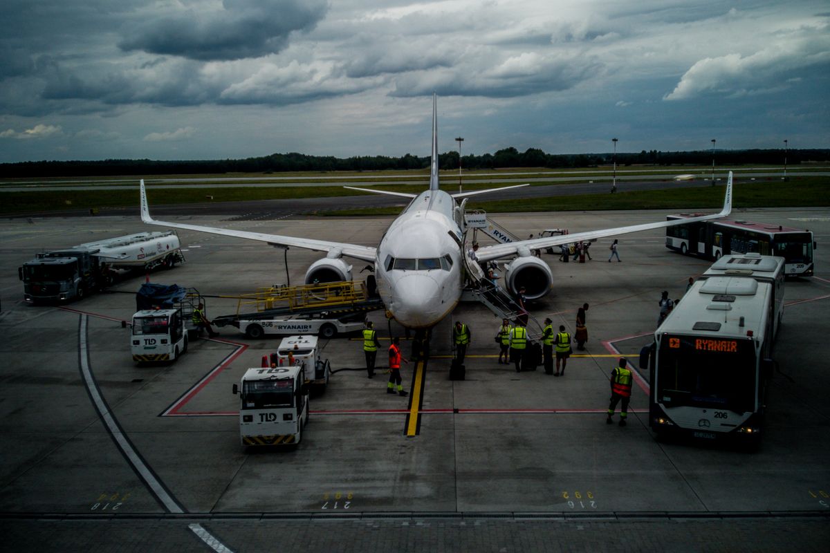 Ground crew working around a parked aircraft